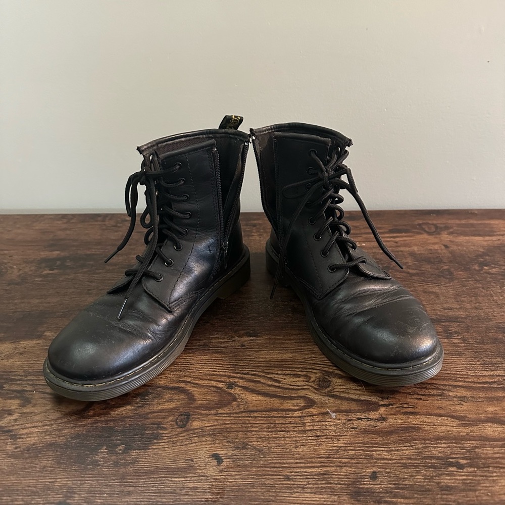 Black Dr. Martens boots; side zip.